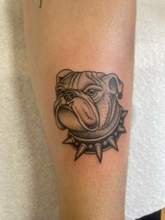 a bulldog head tattoo on the arm