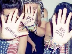 two girls are covering their faces with their hands and the words i love america written on them