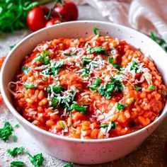 a white bowl filled with red beans and parmesan cheese on top of a table