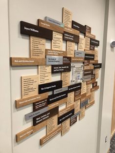 a wall with many different types of wood and metal plaques mounted to it's sides