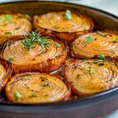 baked potatoes in a pan with herbs on top