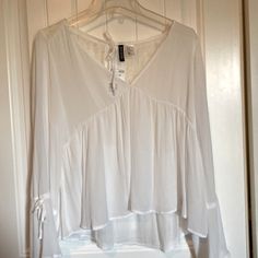 Sheer Blouse With Flares At Cuff With Decorative Ties And Lace On Upper Back. H&m V-neck Tops For Daywear, H&m Spring Shirt, H&m V-neck Tops For Day Out, White Bell Sleeve Tops For Summer, H&m V-neck Blouse For Summer, H&m V-neck Summer Blouse, H&m Spring Daywear Shirt, White Bell Sleeve Blouse For Brunch, White H&m Blouse For Daywear