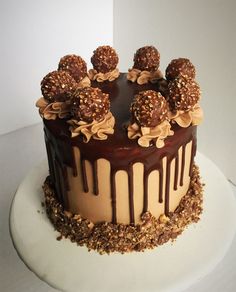 a cake with chocolate frosting and nuts on top