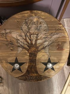 a wooden clock with two stars and a tree on it