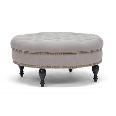 the foot stool is upholstered with gold trimmings and studded details