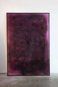 an abstract painting in purple and black on a white wall next to a gray floor