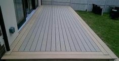 a wooden deck in front of a house