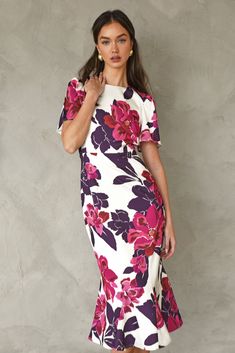 This elegant, midi dress has a slimming structure and bold, flutter sleeves. The modest shape is decorated in pink and purple florals. Midi Dress Floral Short Sleeve Length: 47" Chest: 17 1/4" Waist: 14" Self: 100% Polyester Linning: 100% Polyester Hand wash in cold water. Dry flat. Iron on low heat. Model is wearing a size S Style #: F248D6035 Midi Dress Short Sleeve, Midi Dress Floral, Elegant Midi Dress, Knit Swimwear, Cocktail Attire, Floral Print Midi Dress, Print Midi Dress, Short Dresses Casual, Midi Short Sleeve Dress