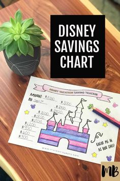 a disney savings chart with a potted plant next to it on a wooden table