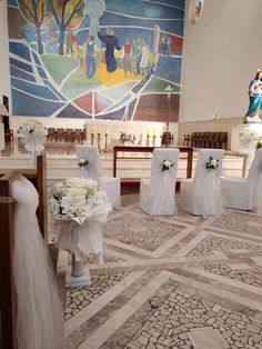 wedding decorations in front of the alter at a church