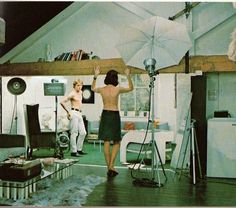 two people in a studio with an umbrella