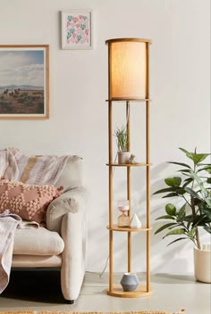 a living room with a couch, chair and floor lamp