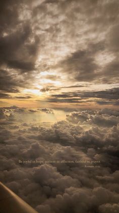 the view from an airplane looking down on some clouds and sun shining through the clouds