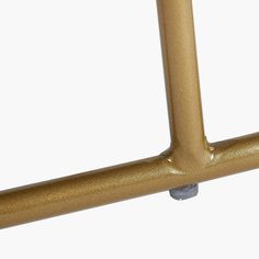 a close up of a gold bicycle frame