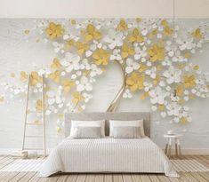 a bedroom with white and yellow flowers on the wall, bed in front of it