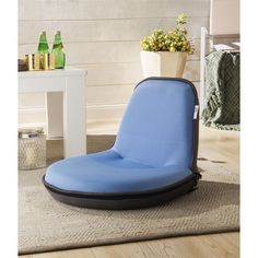 a blue chair sitting on top of a rug