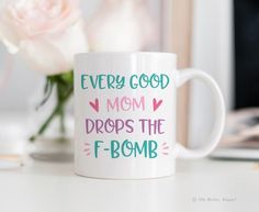 a coffee mug that says, every good mom drops the f bomb