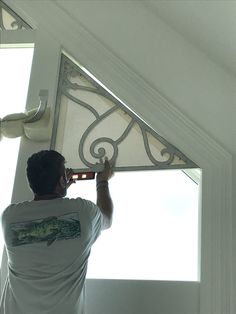 a man that is standing in front of a window