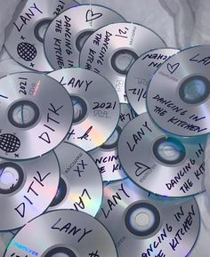 many cd discs with writing on them