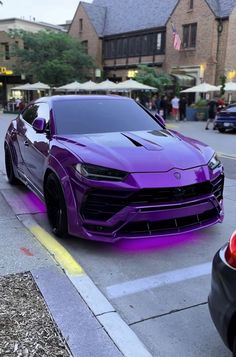 a purple car is parked on the side of the road