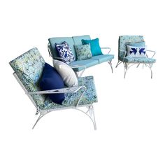 a set of three chairs and two couches with blue pillows on them, sitting next to each other