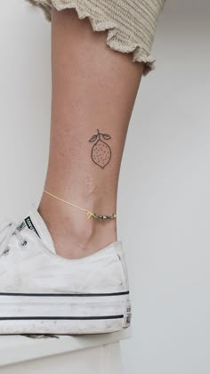 a person with a small tattoo on their ankle