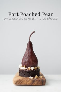 a chocolate cake with blue cheese on top and the words port poached pear