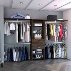 an open closet with clothes hanging on the shelves and shoes sitting on top of them