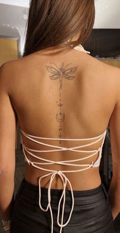 a woman with a dragon tattoo on her back