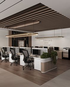 an empty office with desks and chairs in the center, along with potted plants