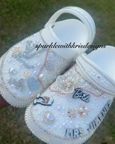 Here comes the Bride! Who says you can't be comfy AND fabulous on your big day?  These custom Crocs are the perfect addition for any special occasion. Rhinestones , pearls, charms, patches and a blinged out name are some of the features we can include.  Creation time is 2-4 weeks (business days). I take pride in my creations and that takes time. Please book early and I'll make sure we communicate throughout the design. 😊 Wedding Crocs Shoes Men, Customized Diamond Crocs Shoes, Bedazzled Wedding Crocs Shoes, Crocks Shoes Wedding, Wedding Crocs Shoes Bride, Bridesmaid Crocs, Wedding Crocs For Bride, White Rhinestone Bridal Jewelry, Bride Crocs