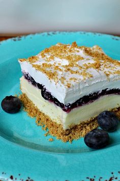 a piece of cake on a plate with blueberries