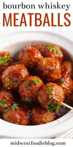 a white bowl filled with meatballs and garnished with parsley on top