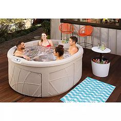 a group of people sitting in an outdoor hot tub