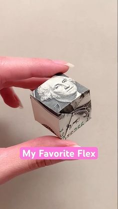 a person holding a money origami box with the words my favorite flex