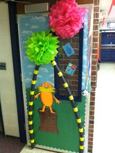 a classroom door decorated with paper flowers and decorations