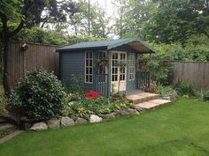 a small garden shed in the middle of a yard