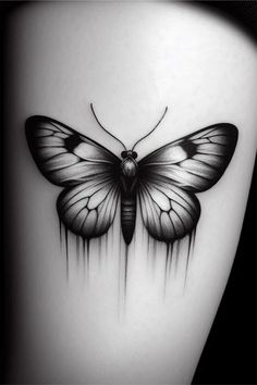 a black and white photo of a butterfly on the side of a woman's thigh