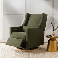 a green recliner chair sitting on top of a rug next to a small table