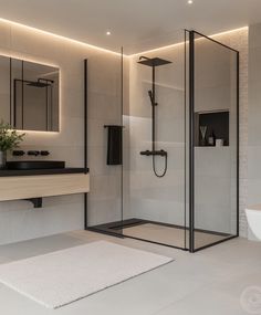 a bathroom with a shower, sink and mirror