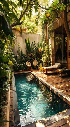 an outdoor swimming pool surrounded by greenery and wooden decking with chaise lounge chairs