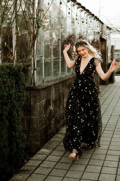 This bestselling style is now back in stock! The Starry Eyed Sequin Star Mesh Maxi Dress is a Confête favorite. Starry Eyed features an a-lined silhouette, deep v-neck, glitter stars and a slight ruffle cap sleeve. Fully lined. Hidden back zipper enclosure. 100% poly. Hand wash cold. Comes in black and gold. Pictured in S and L. Mesh Star Dress, Black Starry Dress, Velaris Starfall Dress, Witchy Wedding Guest Dress, Black Celestial Dress, Celestial Prom Dress, Black Sequin Bridesmaid Dress, Black Dress With Stars, Starfall Dress