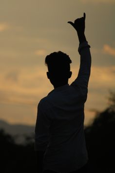 a man holding his hand up in the air