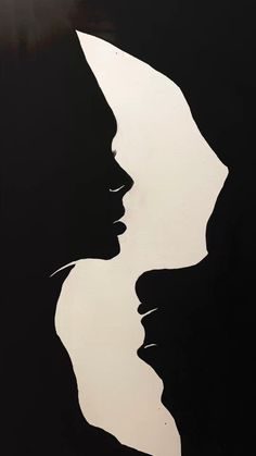 the silhouettes of two women are shown in black and white, with one woman's face to the side