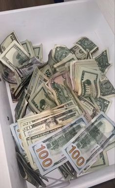 a box filled with lots of money sitting on top of a table