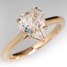 an engagement ring with a pear shaped diamond