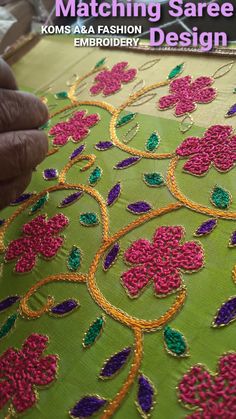 a person is working on an embroidered cloth