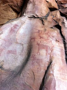 some rocks with paintings on them in the desert