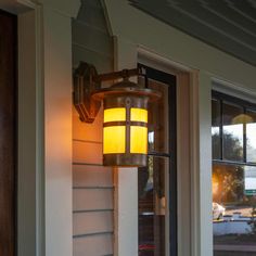 a light that is on the side of a building next to a door and window