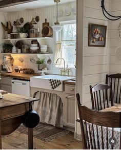 the kitchen is clean and ready to be used for cooking or baking, with dishes on the shelves above the sink